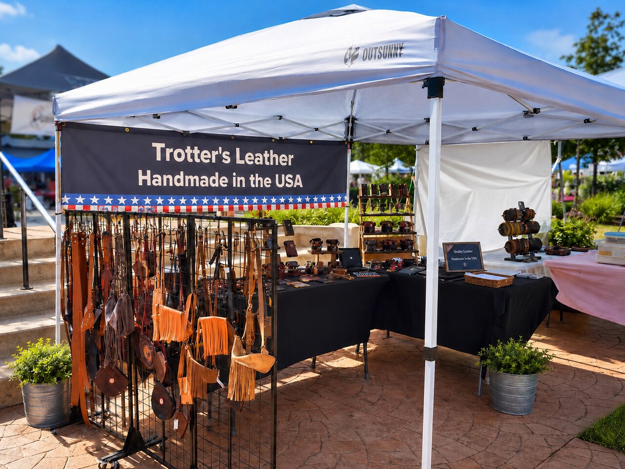 Trotter’s Leather market booth displaying handmade leather goods